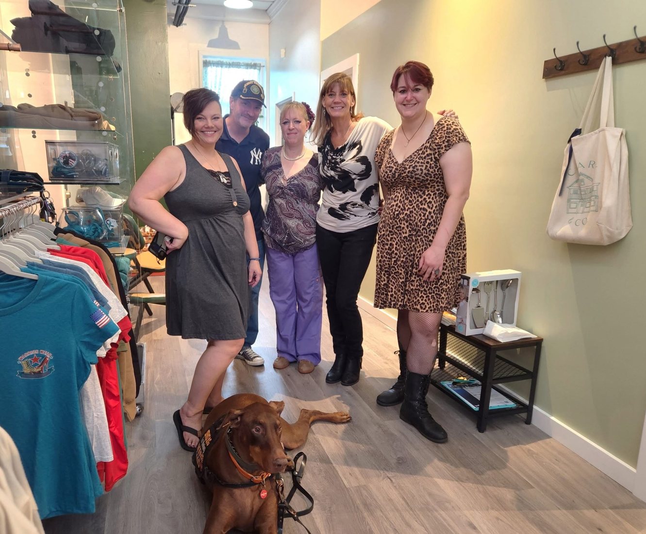 A group of opening-day guests smiling inside the studio.